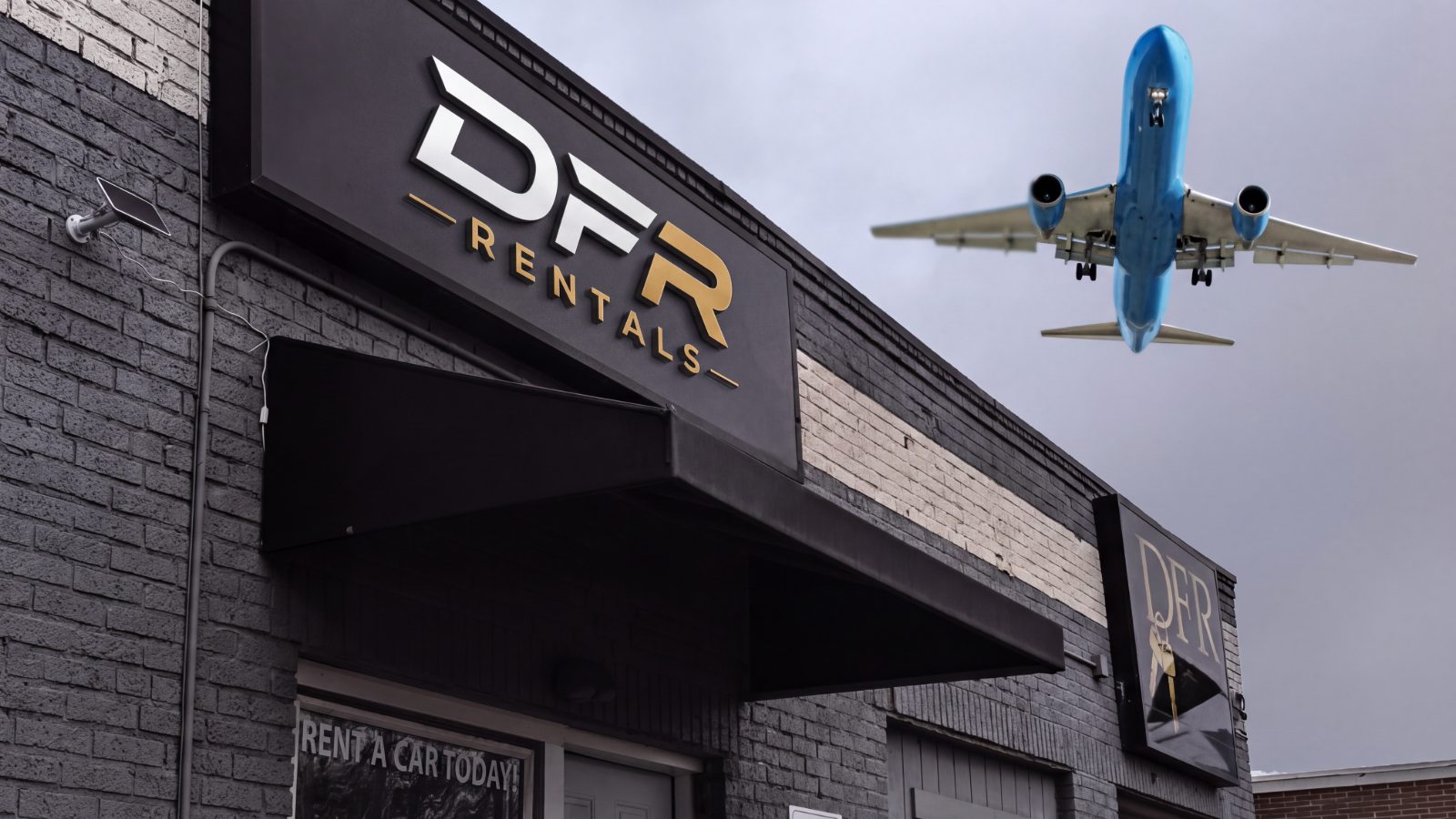 The DFR Rentals storefront in Cleveland with a plane passing overhead